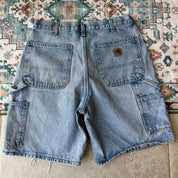 Carhartt denim baggy shorts blue with classic logo and carpenter pockets.