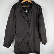 Canada Goose black parka jacket with logo, slight tear near pocket, missing hood.