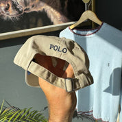 Polo Ralph Lauren tan cap with embroidered logo and adjustable strap.