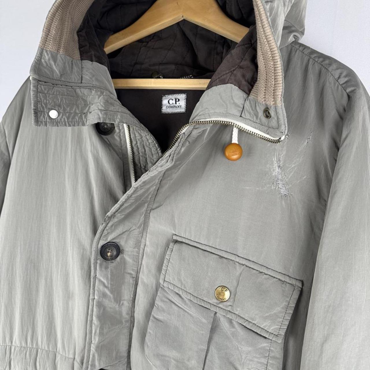 CP Company multi-colour utility parka jacket with multiple pockets and hood.