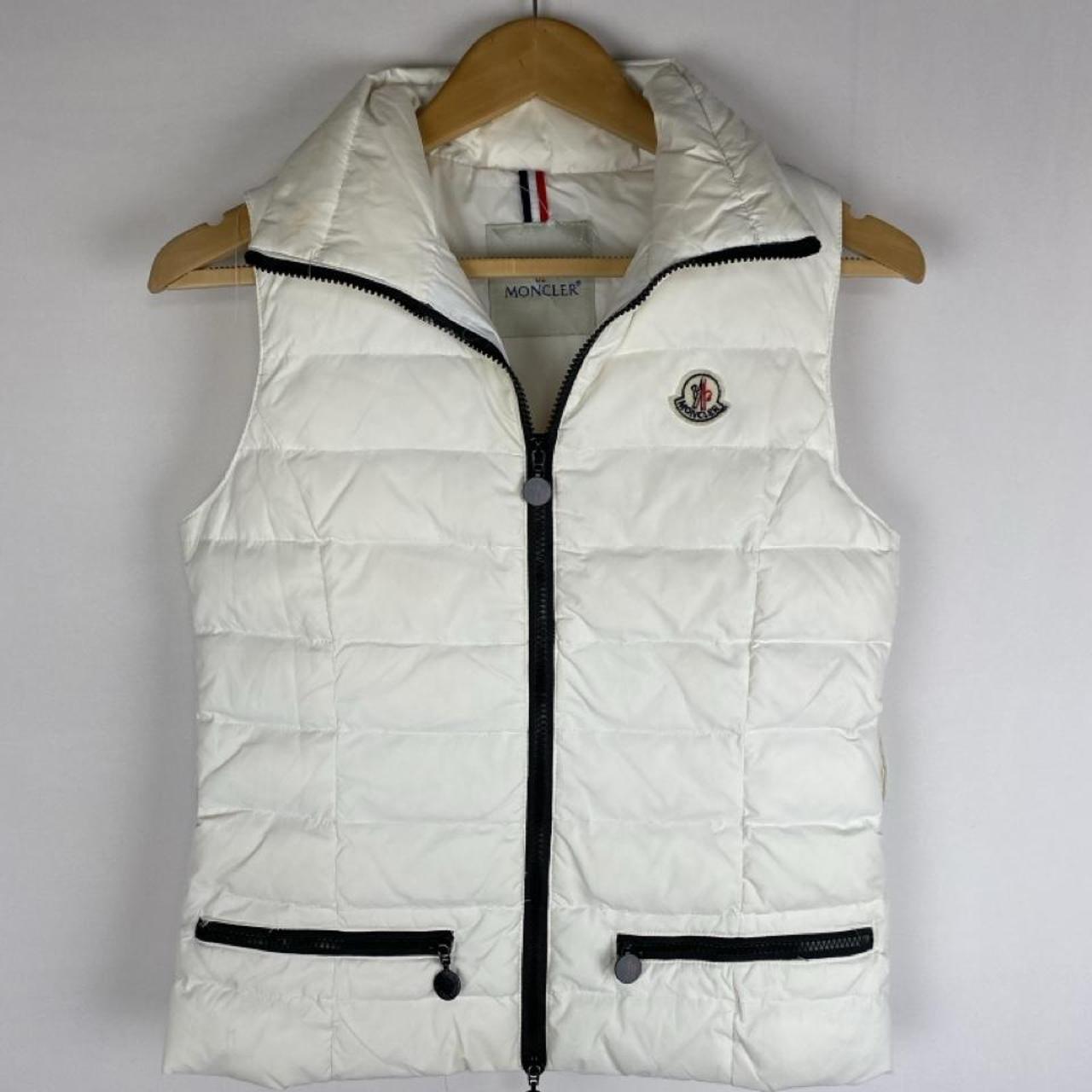 Moncler white down puffer gilet with logo detail and missing belt.