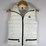 Moncler white down puffer gilet with logo detail and missing belt.