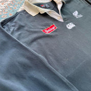Canterbury men's polo shirt black with All Blacks logo and rugby pattern details.