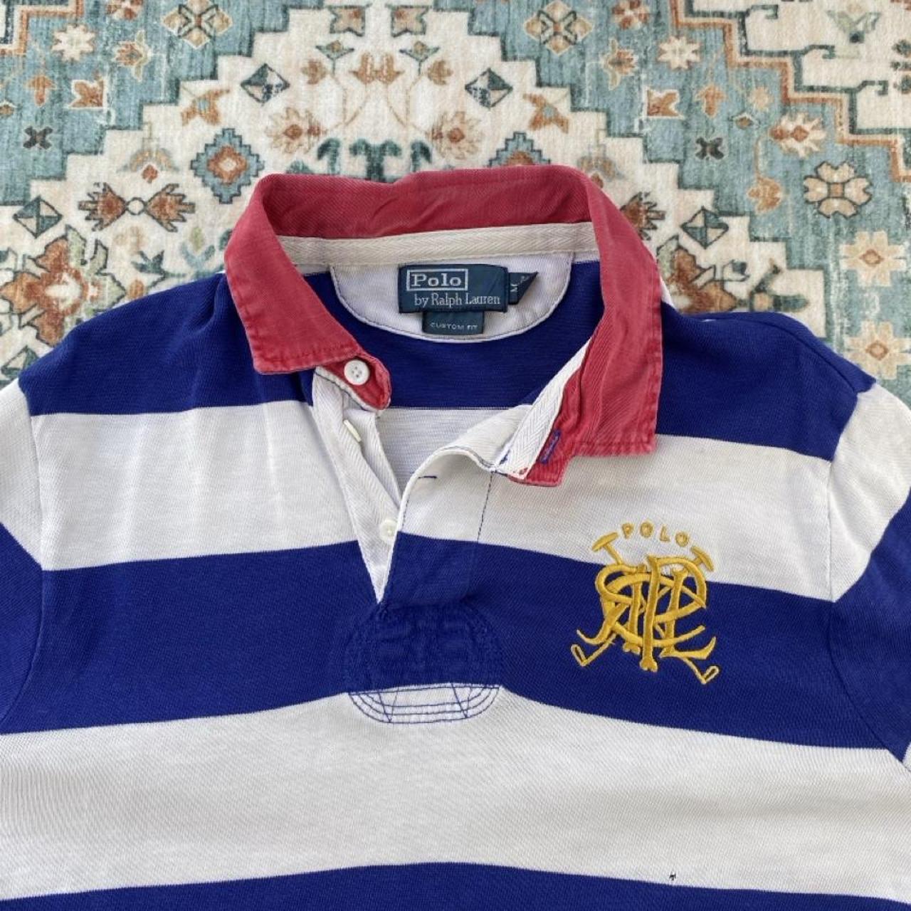 Polo Ralph Lauren blue and white striped rugby polo shirt with embroidered logo.
