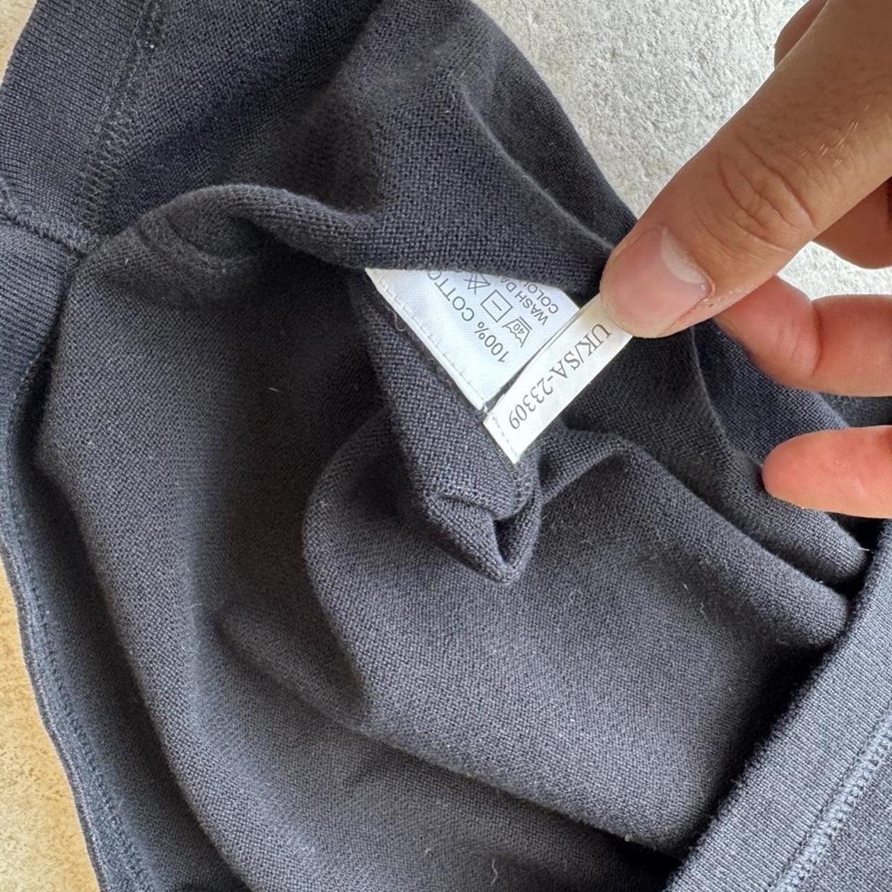 Yves Saint Laurent black knitted sweatshirt with embroidered YSL logo and slim fit.