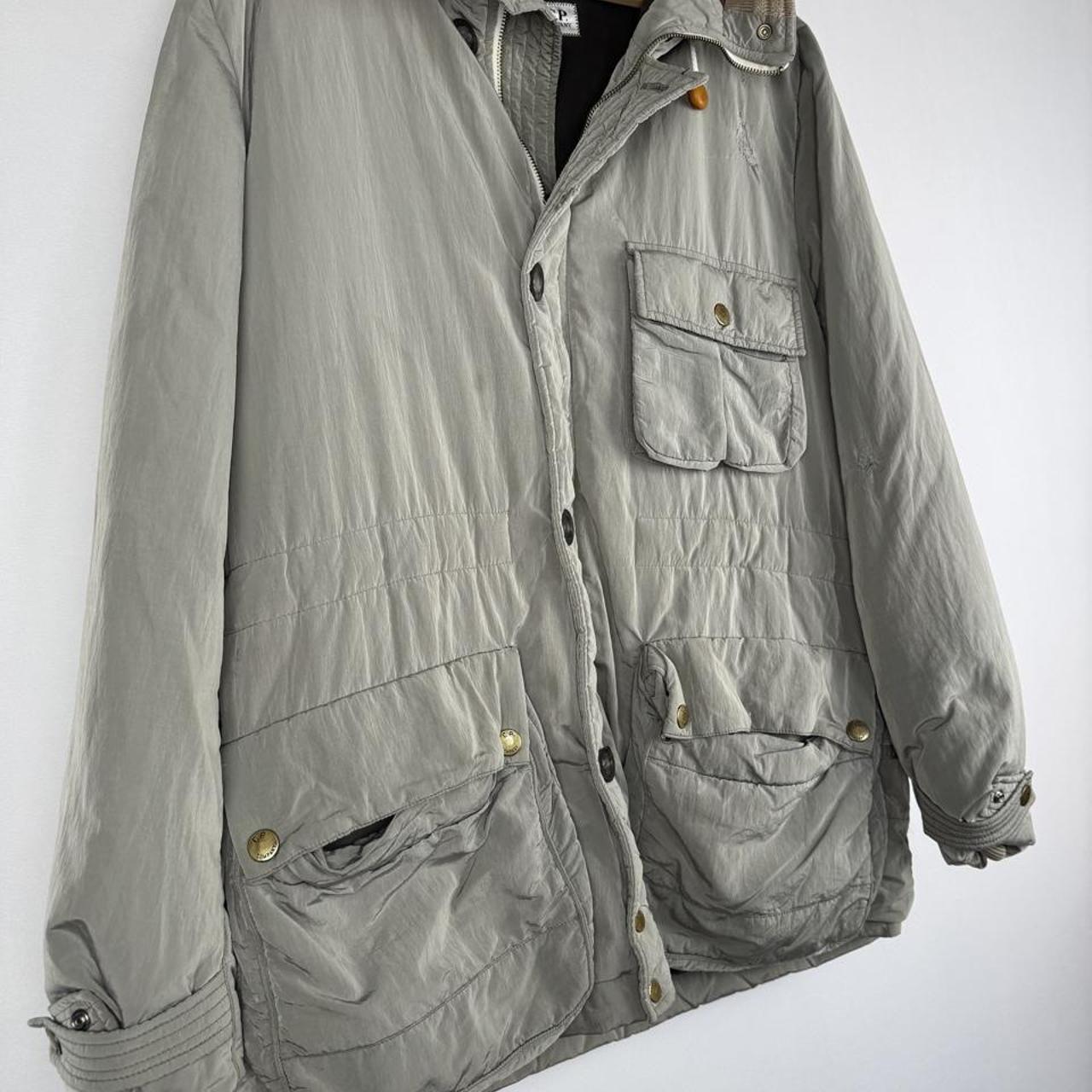 CP Company multi-colour utility parka jacket with multiple pockets and hood.