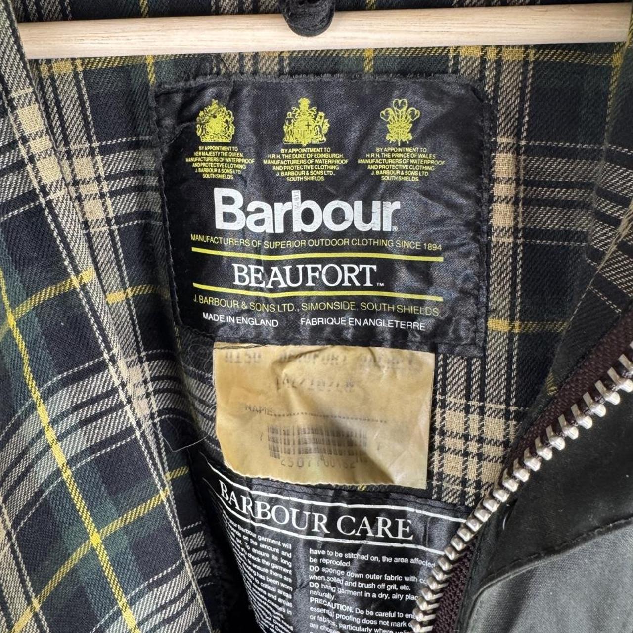 Barbour green waxed Beaufort jacket with attached hood and classic logo detail.