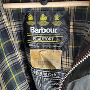 Barbour green waxed Beaufort jacket with attached hood and classic logo detail.
