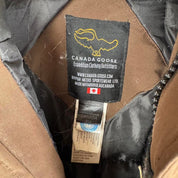 Canada Goose brown parka jacket with logo patch and utility pockets.