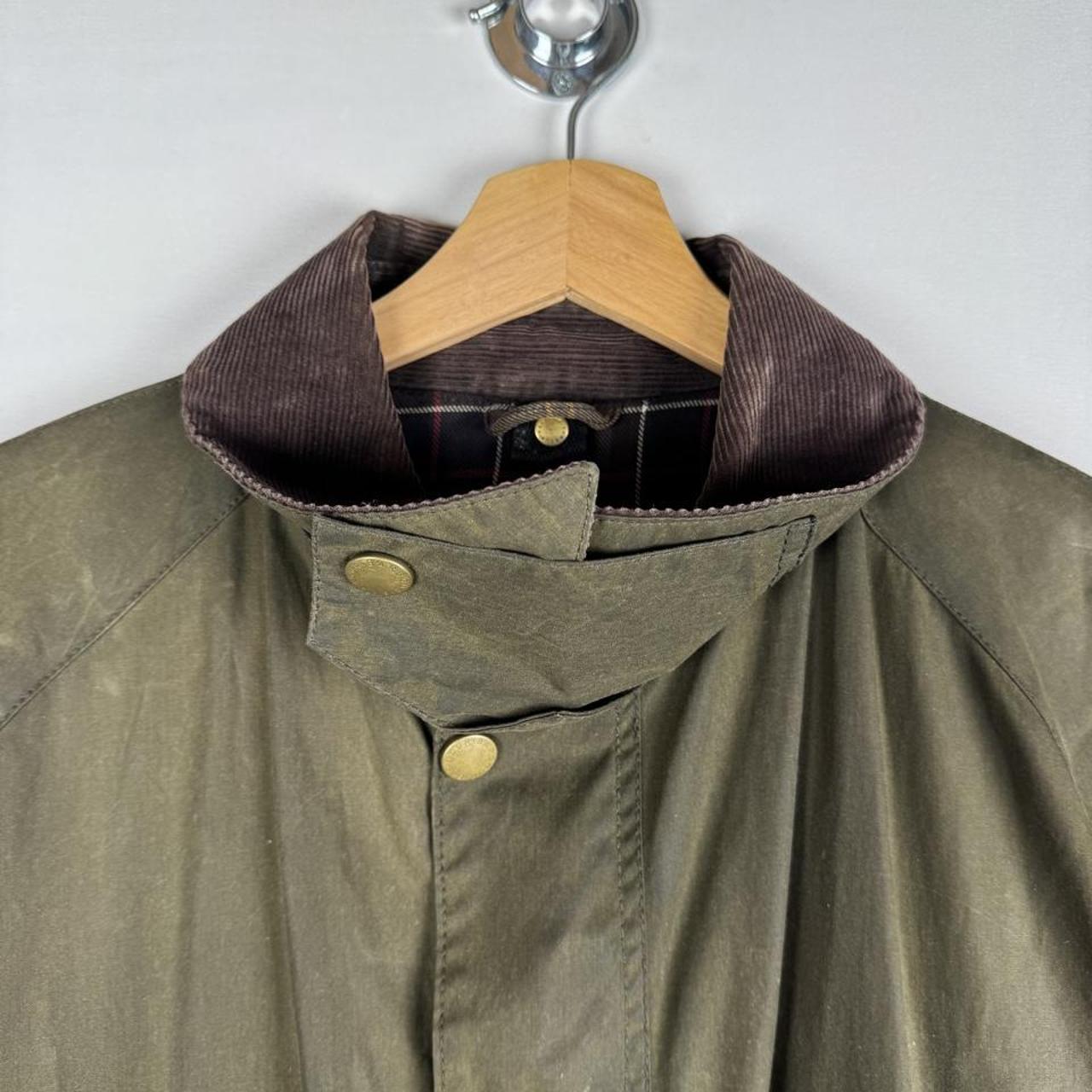 Barbour green wax jacket with logo, classic design, and durable material.