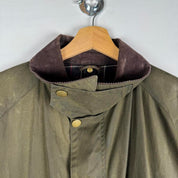 Barbour green wax jacket with logo, classic design, and durable material.