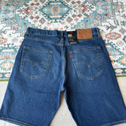 Levi's denim 501 shorts blue with classic logo patch and five-pocket design.