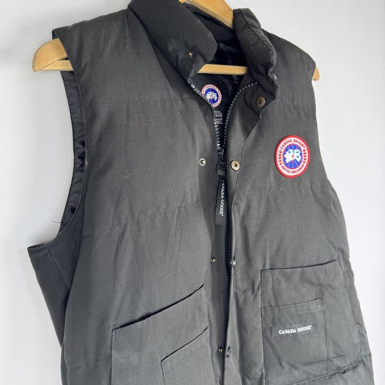Canada Goose black puffer gilet with logo patch and quilted design.