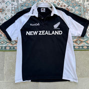 Kooga men's polo shirt, green with embroidered New Zealand logo and rugby collar.