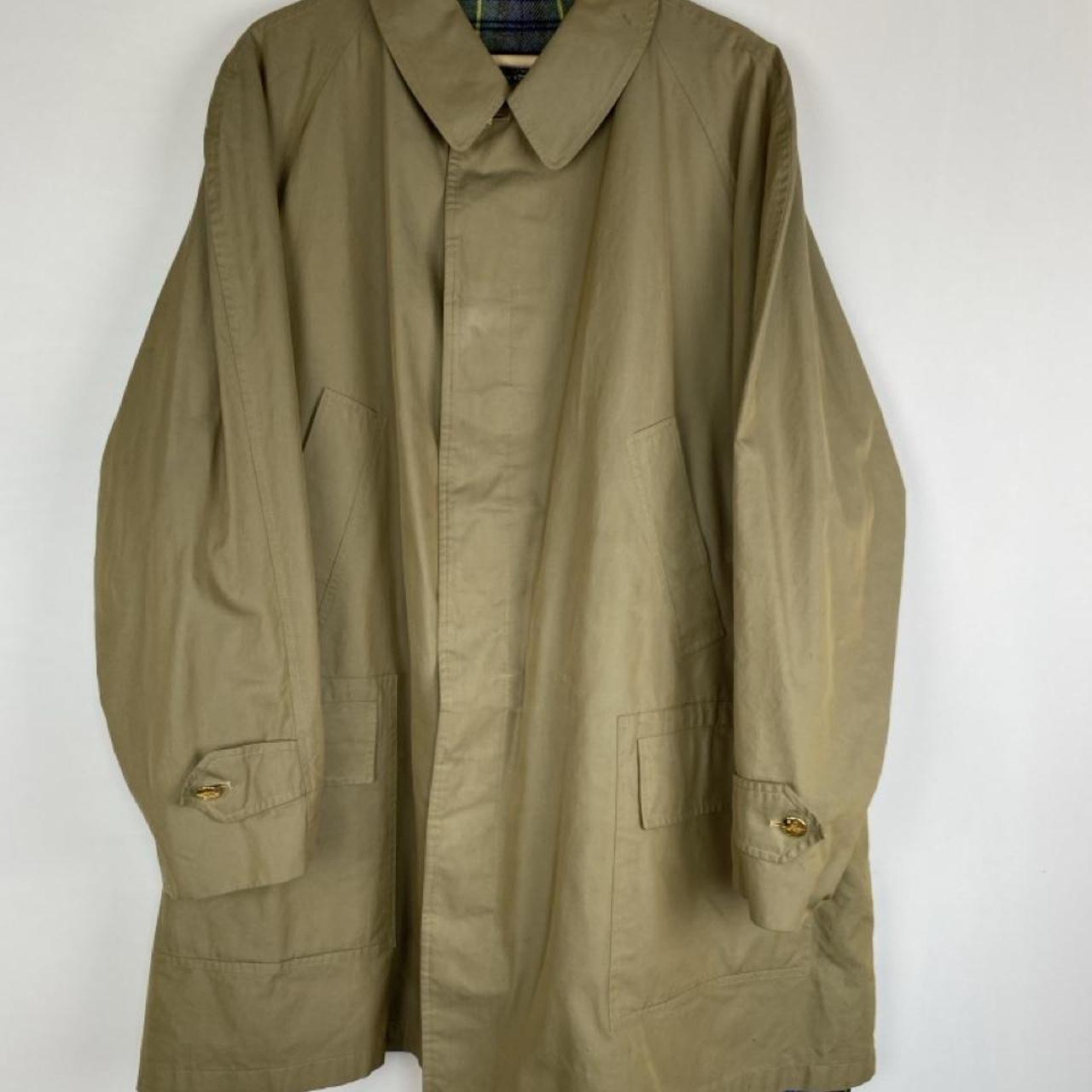 Burberry khaki trench coat with plaid lining and classic logo detail.