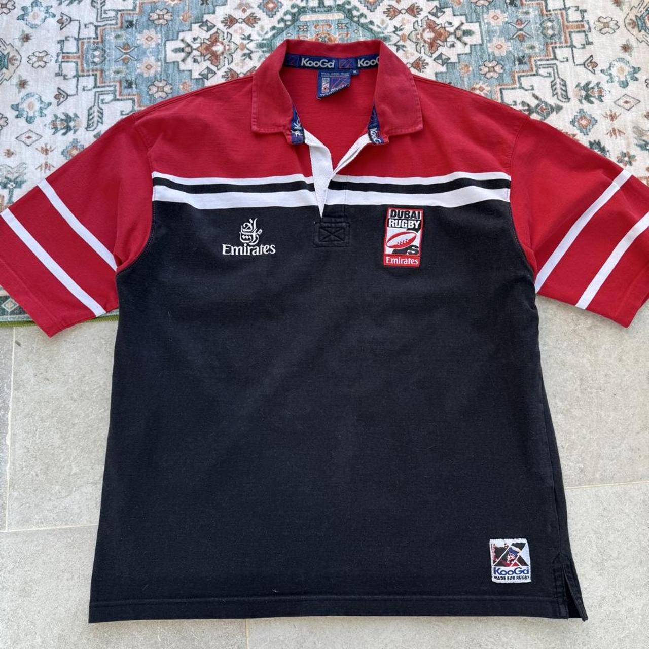 Kooga men's rugby polo shirt, navy blue, embroidered Dubai 7s logo, cotton material.