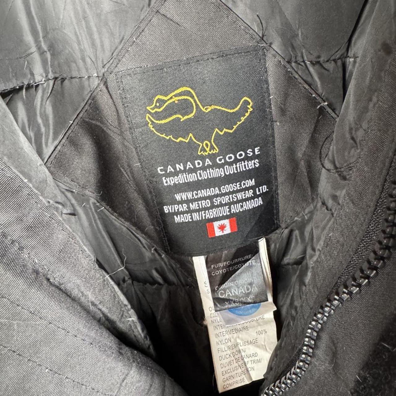 Canada Goose black and brown parka jacket with logo and utility pockets.