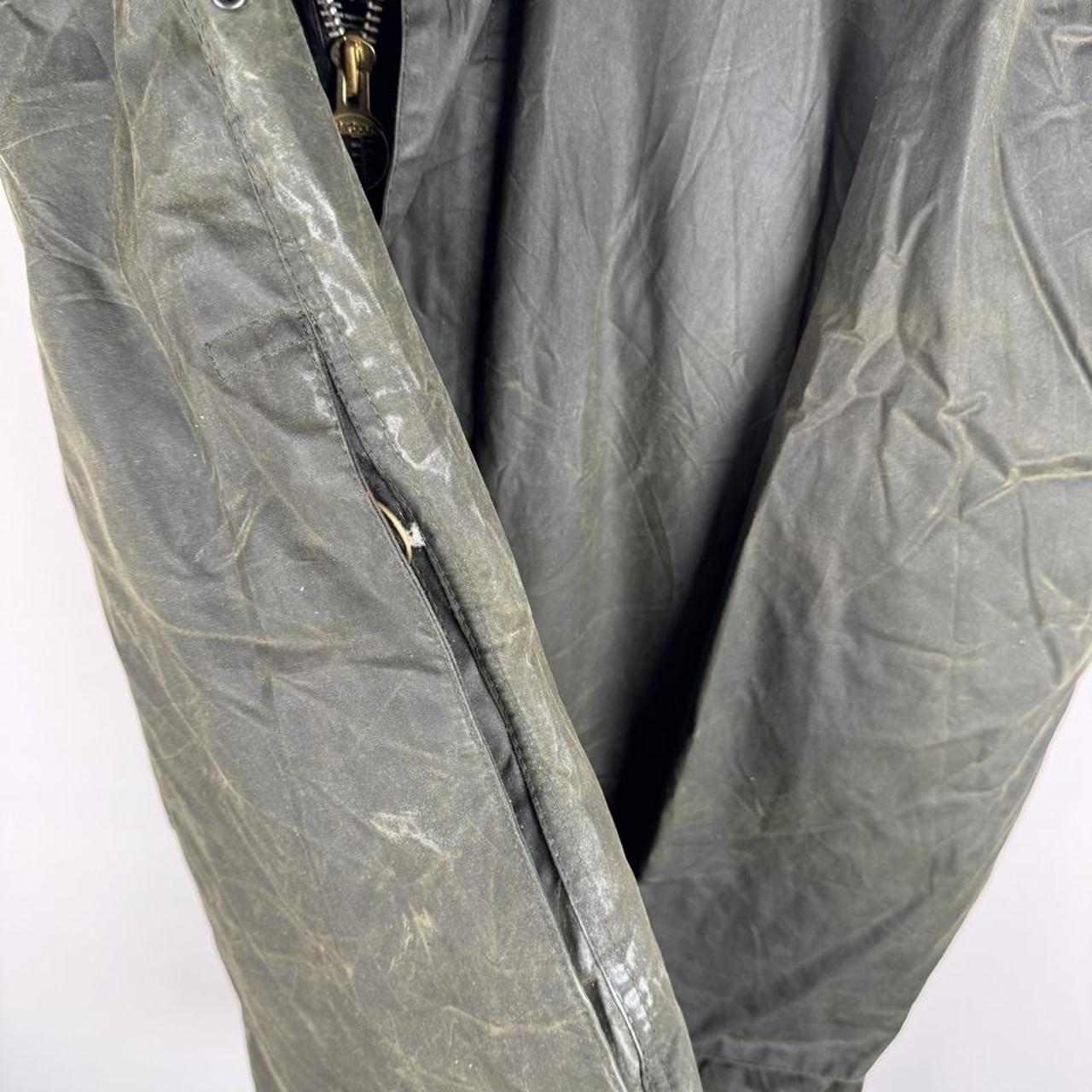 Barbour green waxed Beaufort jacket with attached hood and classic logo detail.