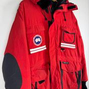 Canada Goose red parka jacket with logo patch and thick insulated material.