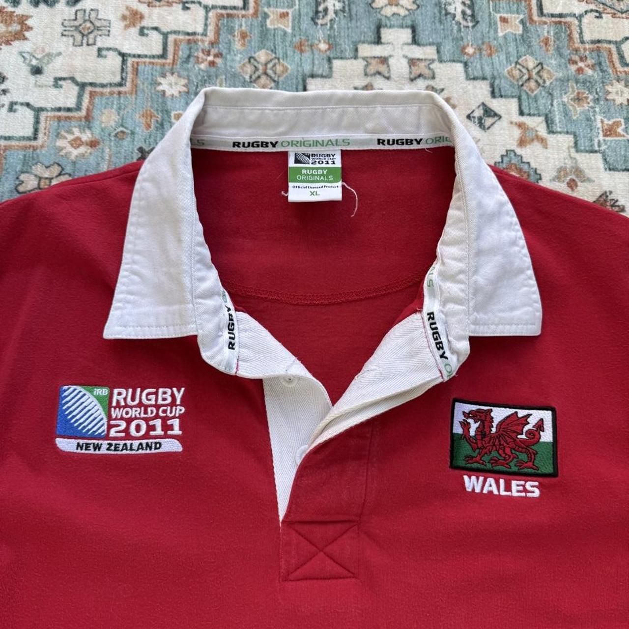 Wales red rugby polo shirt with embroidered logo and World Cup details.