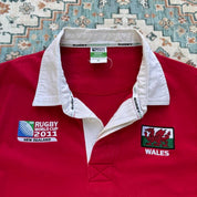 Wales red rugby polo shirt with embroidered logo and World Cup details.