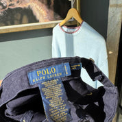 Polo Ralph Lauren navy cap with yellow embroidered logo and adjustable strap.