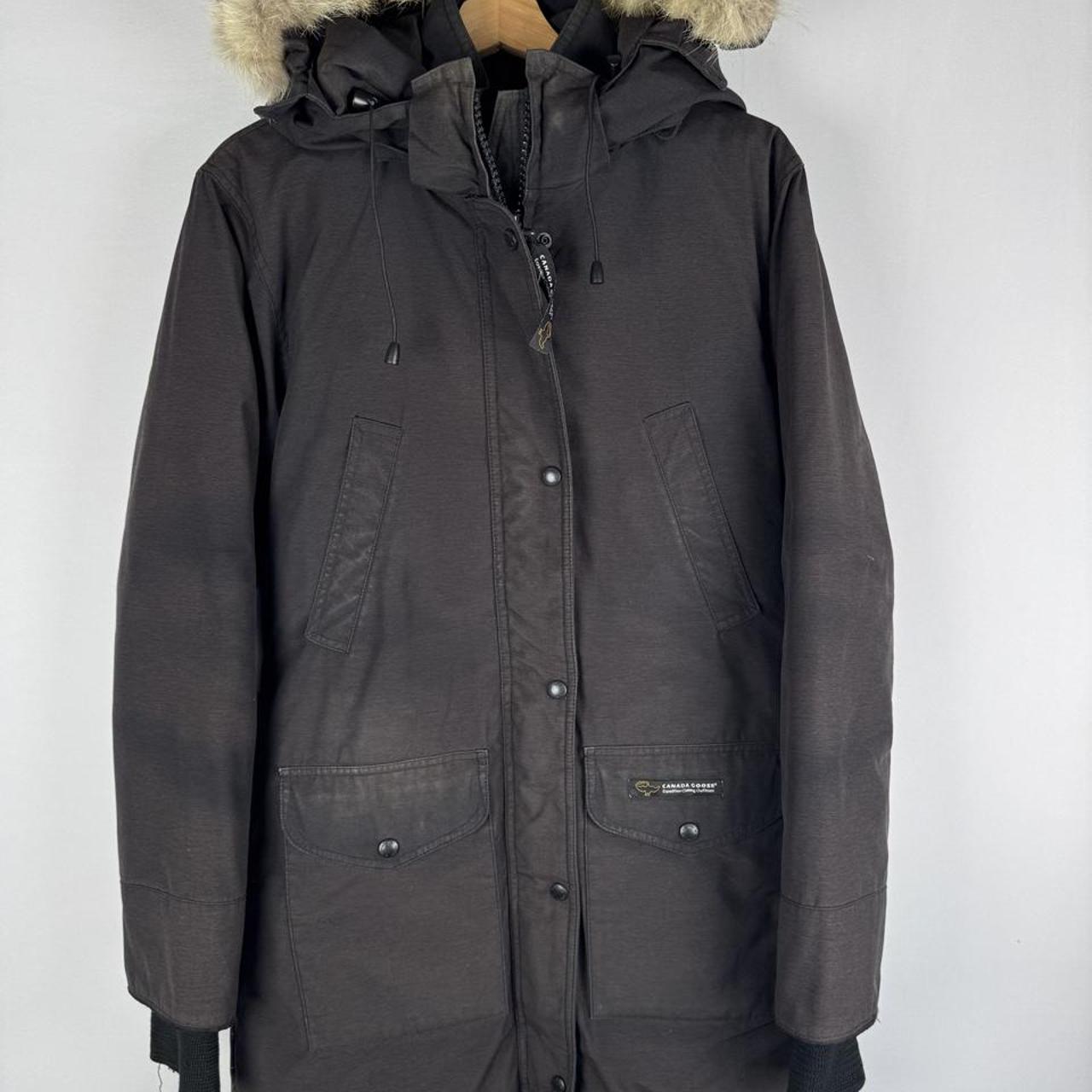 Canada Goose cream parka jacket with logo patch and slightly faded finish.