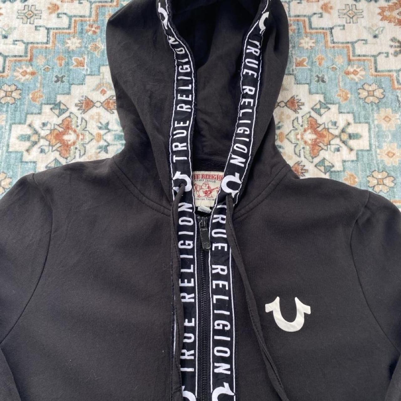 True Religion black and white full zip hoodie with logo and contrast stitching.
