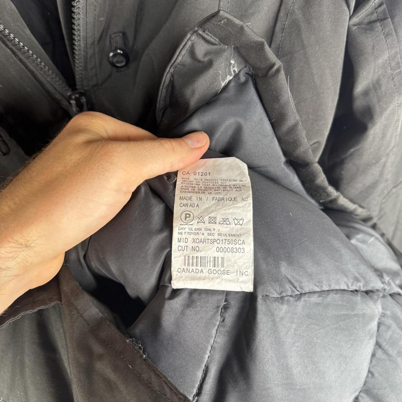 Canada Goose black parka jacket, medium size, features logo patch and sleek design.