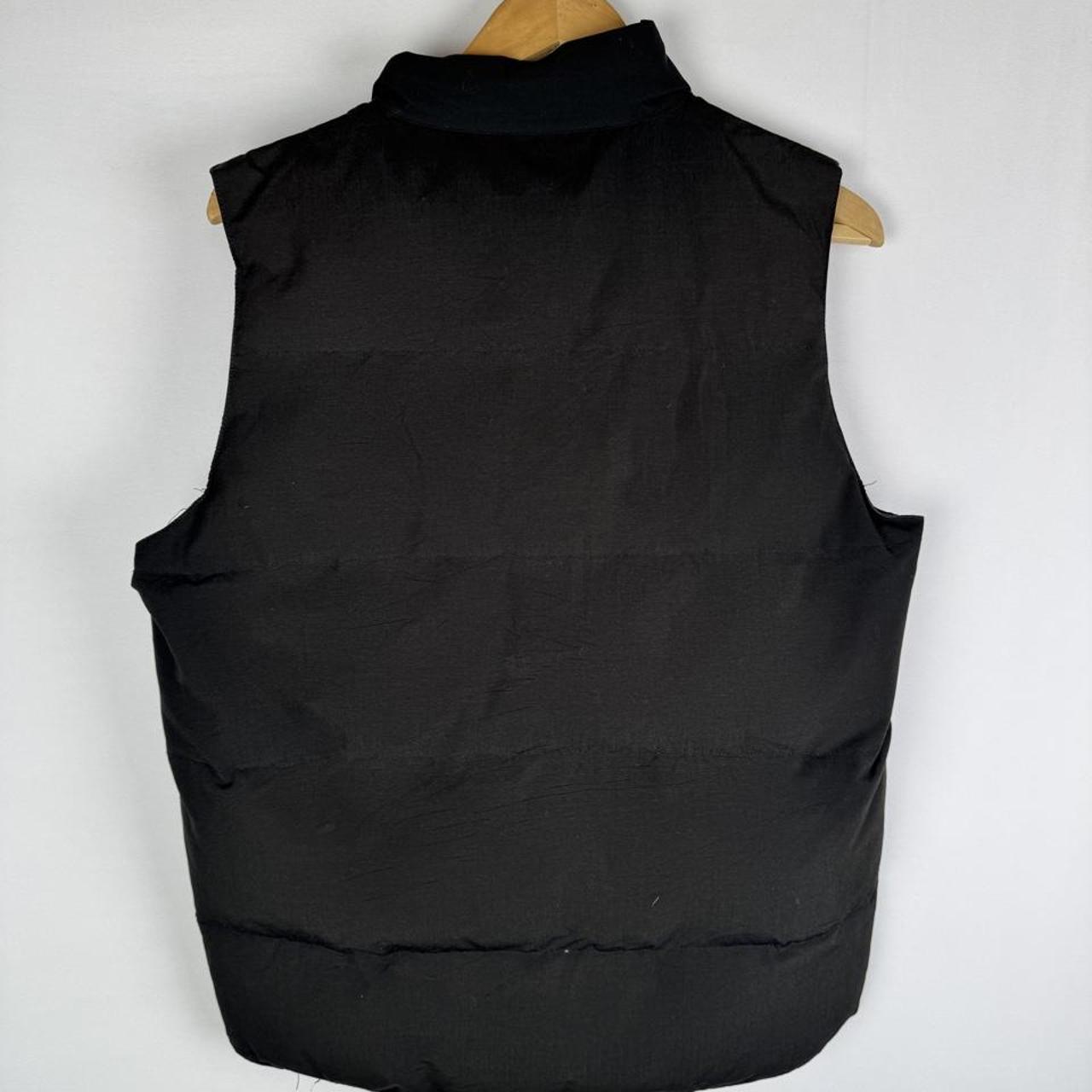 Canada Goose black puffer gilet with logo patch and quilted design.