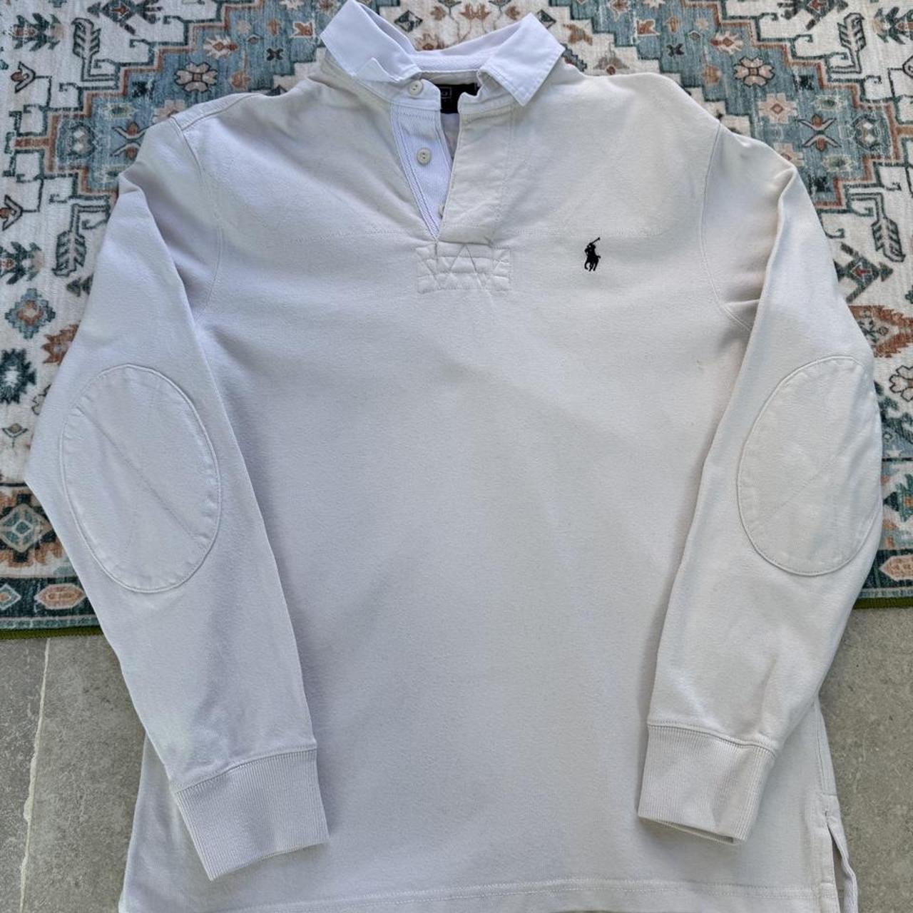 Polo Ralph Lauren cream rugby polo shirt with embroidered logo and classic collar.