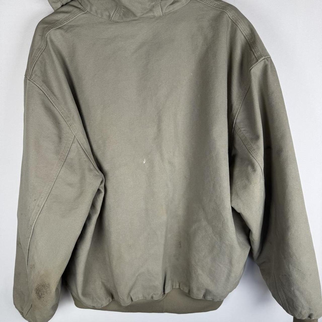 Carhartt active jacket, orange, oversized fit, visible logo, durable material.