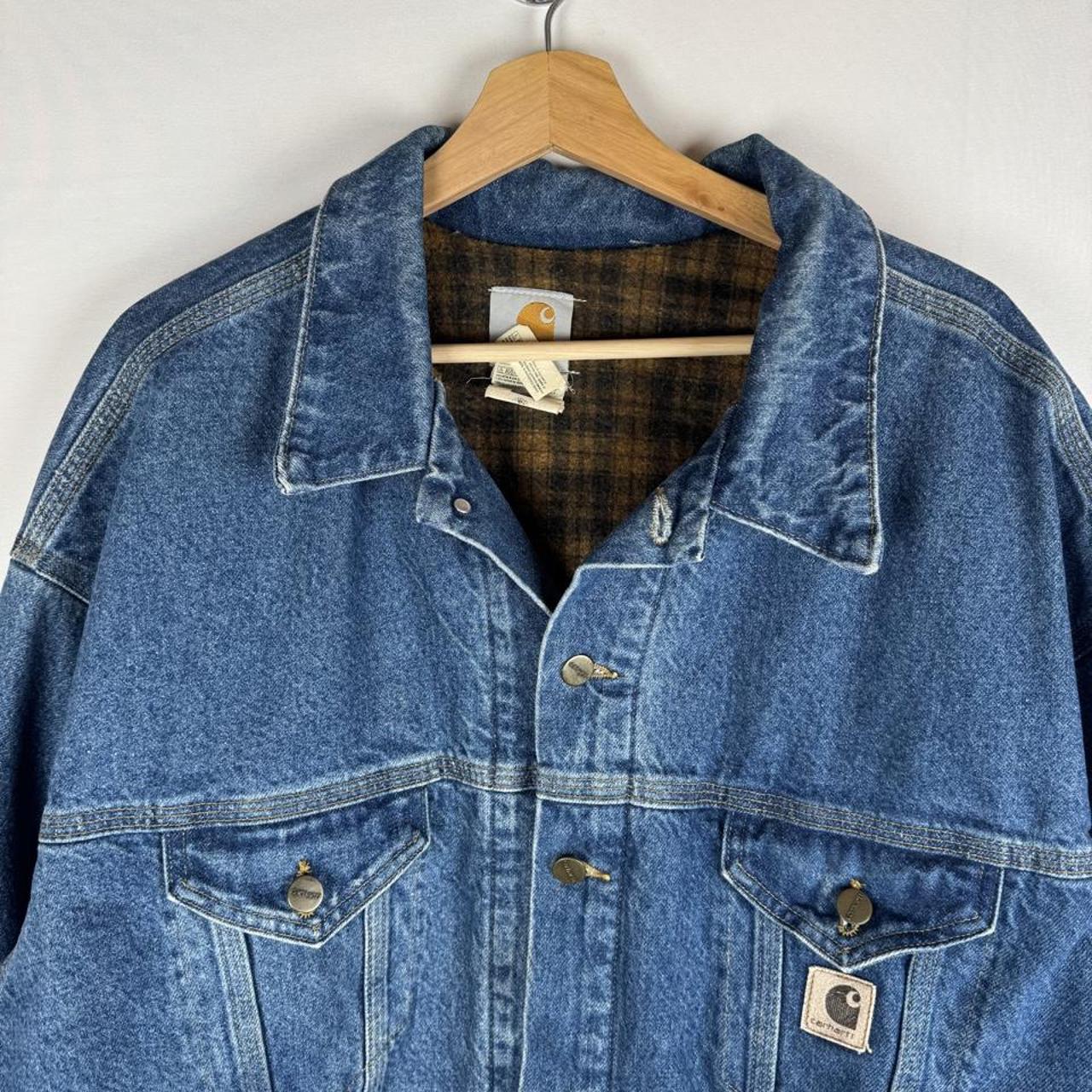Carhartt denim trucker jacket 1990s style with classic logo and relaxed fit.