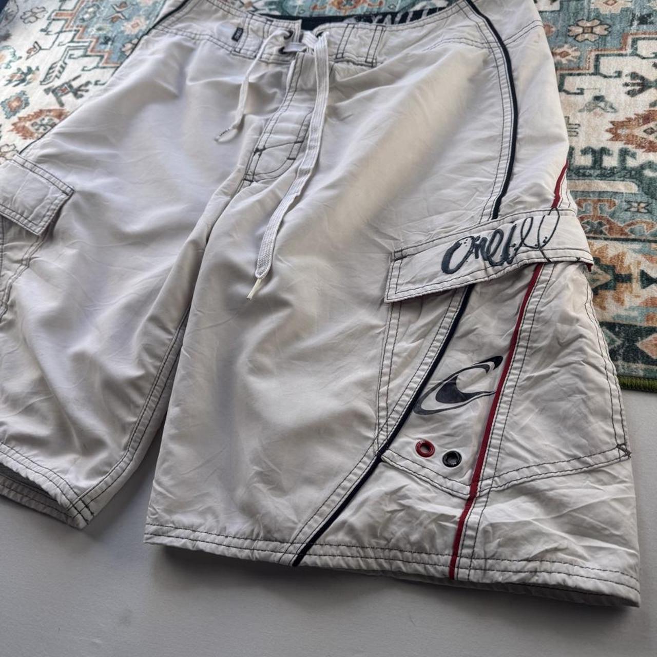 O'Neill cream board shorts with embroidered logo and relaxed baggy fit.