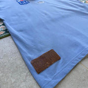 NSW Rugby League blue polo shirt with embroidered logo and vintage 1990s design.