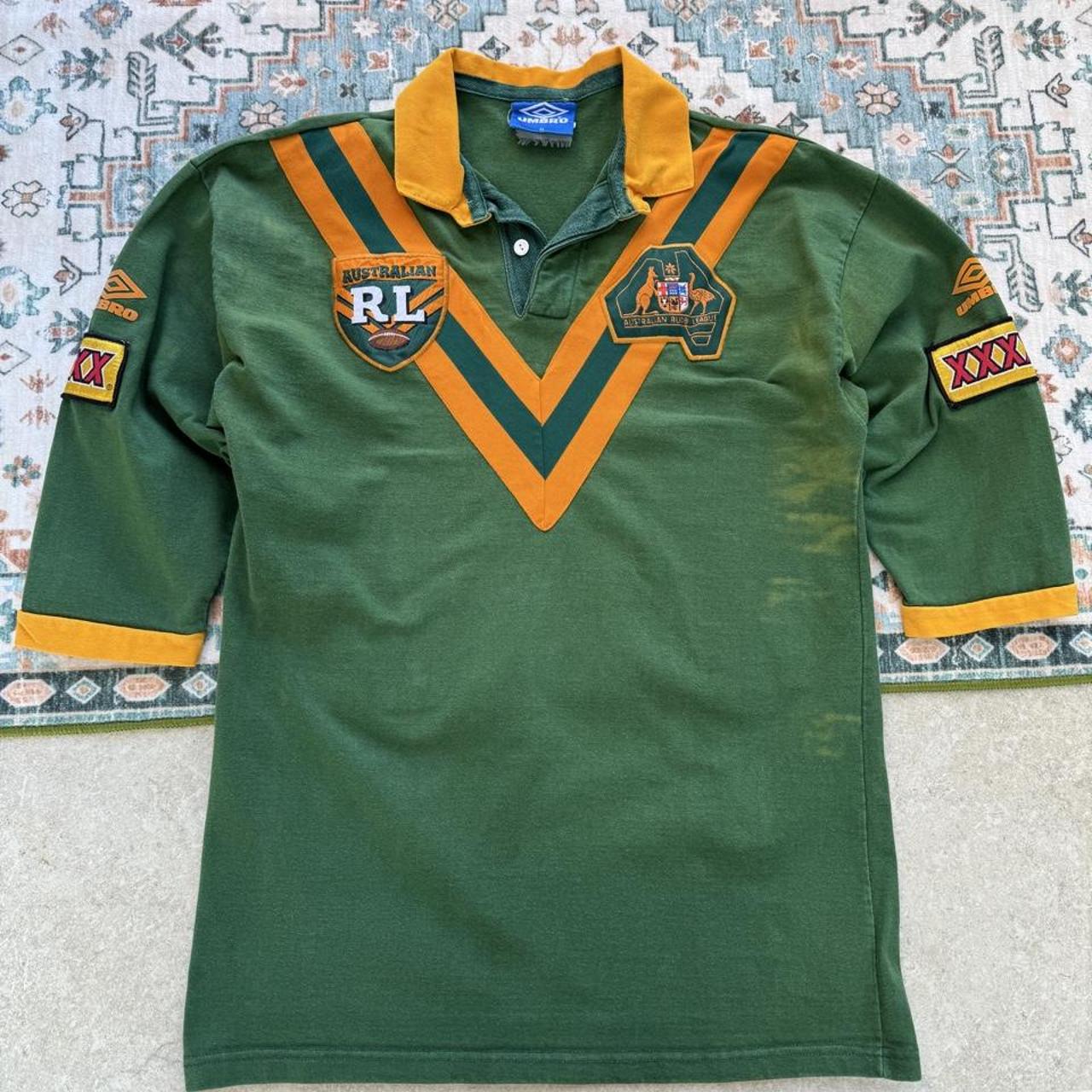 Umbro men's polo shirt green with Wallabies logo and rugby league pattern.