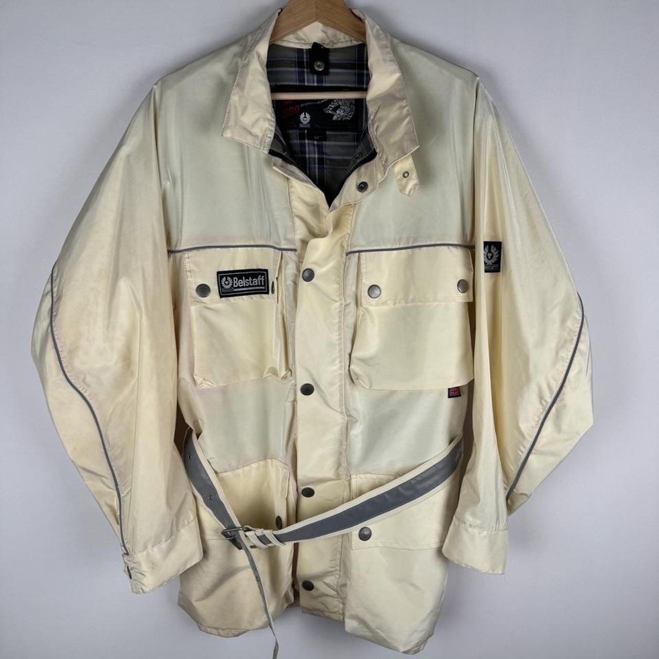 Belstaff cream motorcycle jacket with logo patch and shell material details.