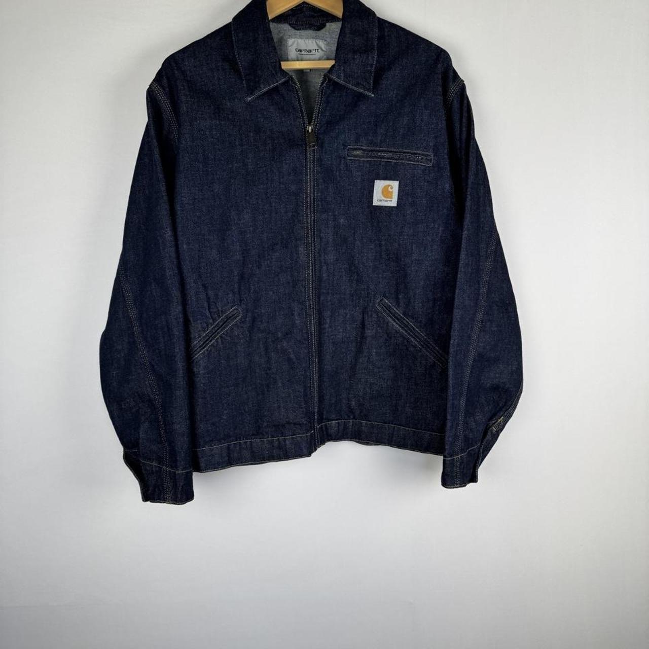 Carhartt WIP blue denim jacket with logo patch and classic design details.