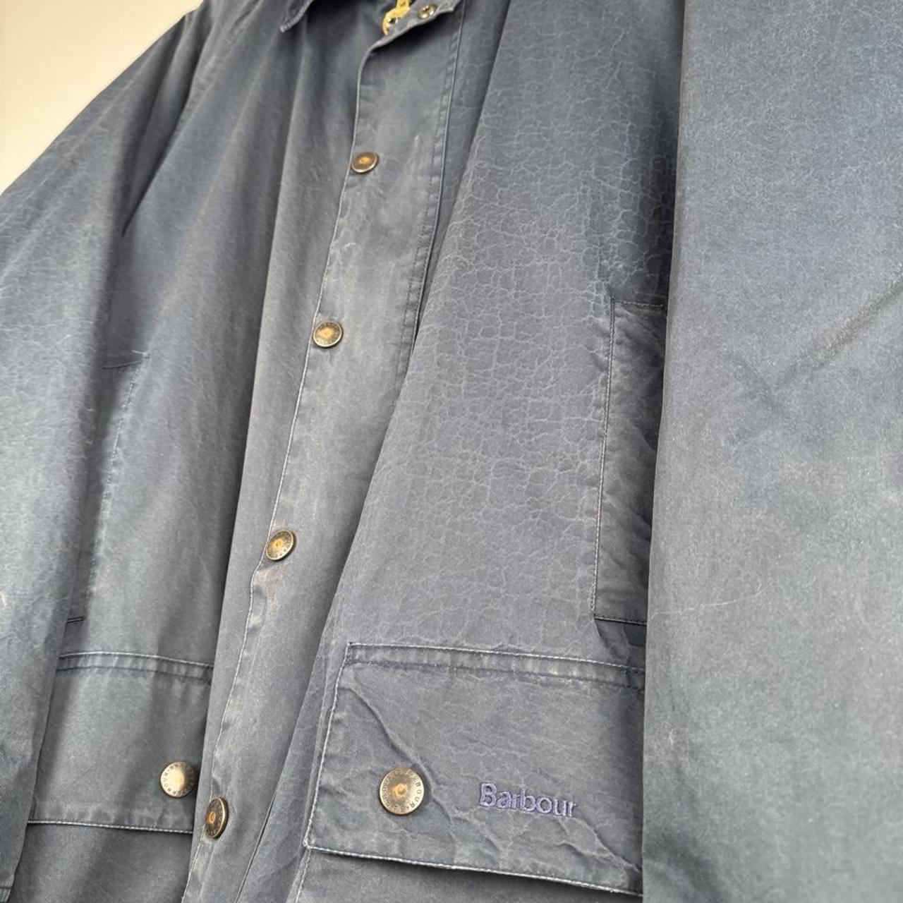Barbour blue lightweight jacket with logo, relaxed fit, and classic design.