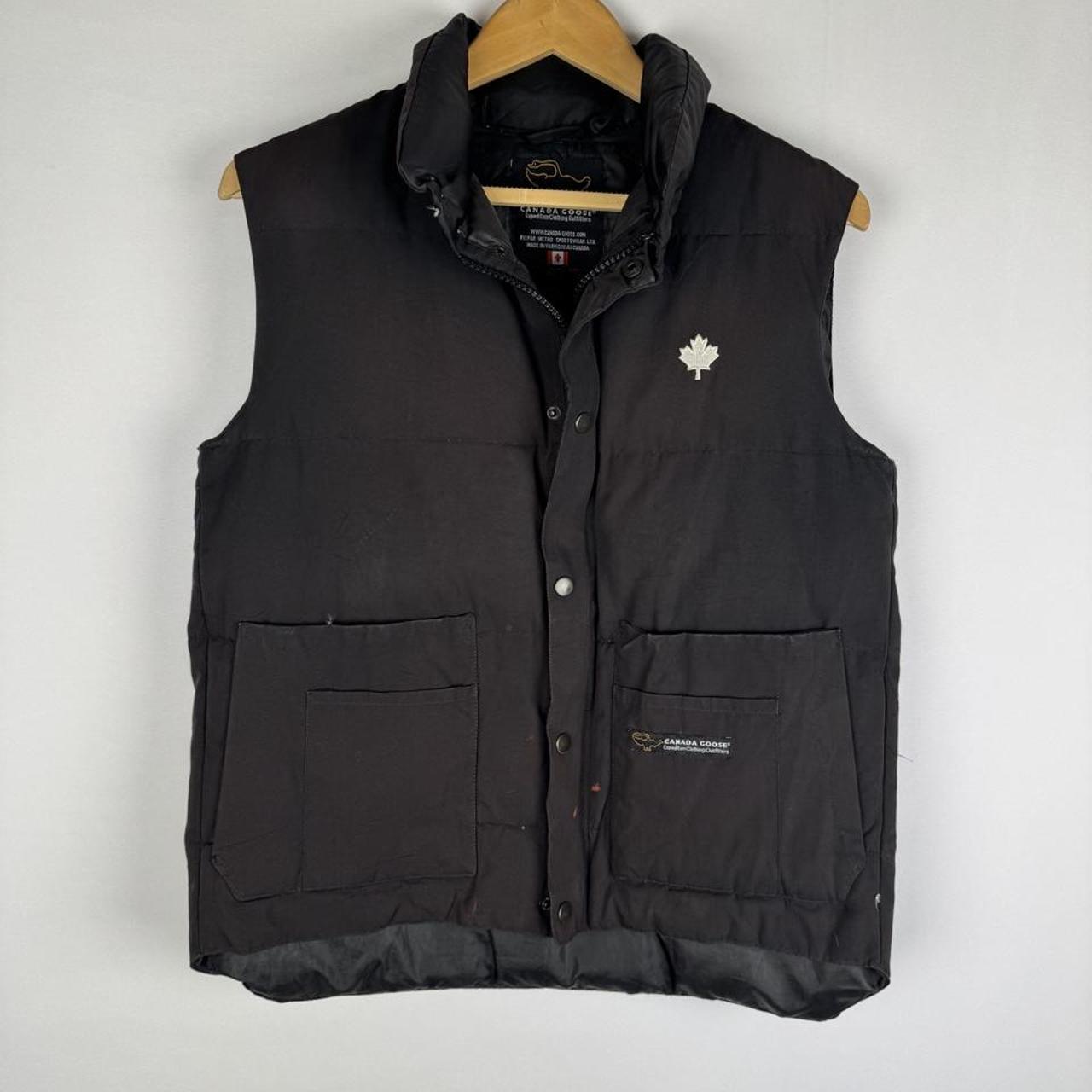 Canada Goose black down puffer gilet with logo patch and quilted texture.