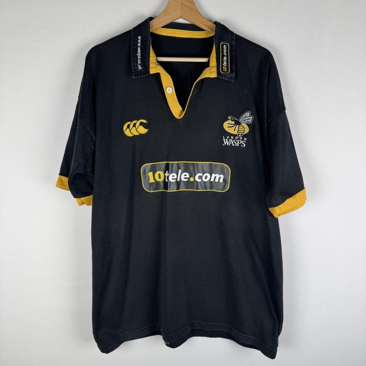 Canterbury men's rugby polo shirt, black and gold, featuring Wasps logo and classic design.