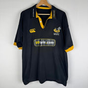 Canterbury men's rugby polo shirt, black and gold, featuring Wasps logo and classic design.