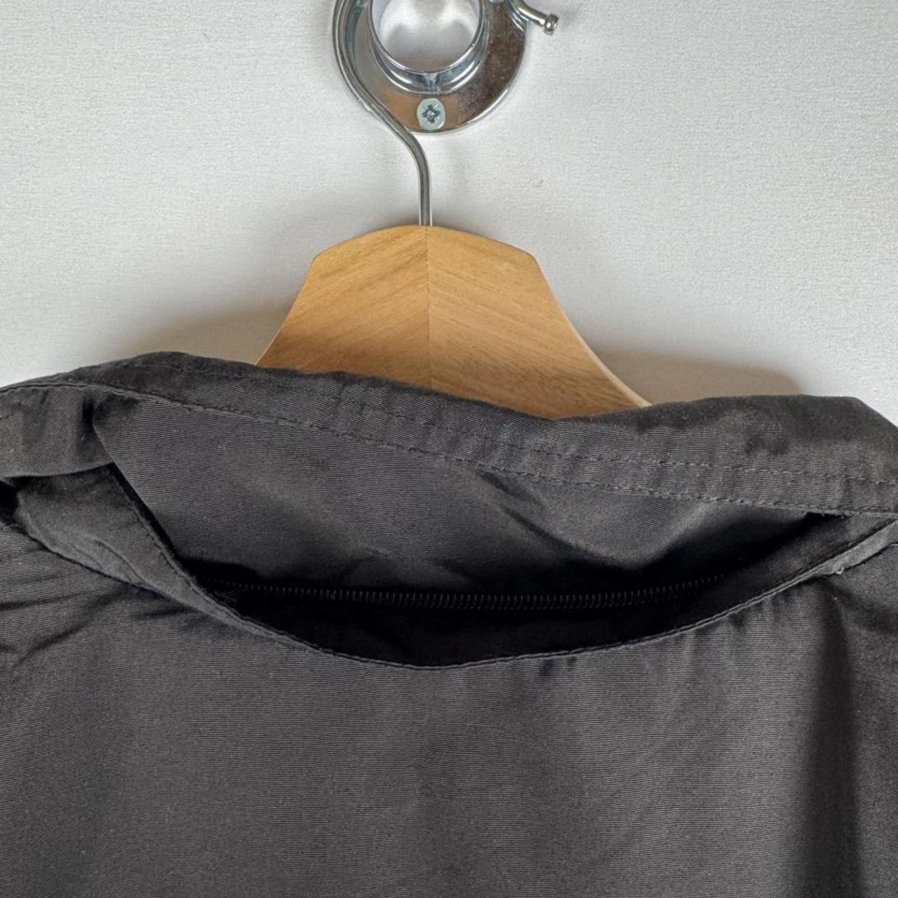 Canada Goose black parka jacket with logo, slight tear near pocket, missing hood.