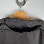 Canada Goose black parka jacket with logo, slight tear near pocket, missing hood.
