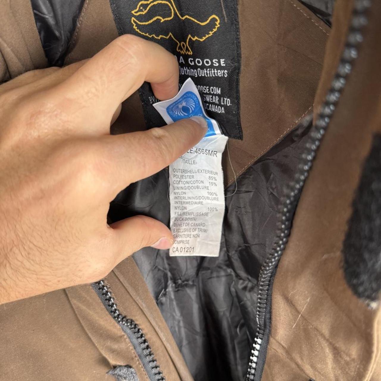 Canada Goose brown parka jacket with utility pockets and logo patch.