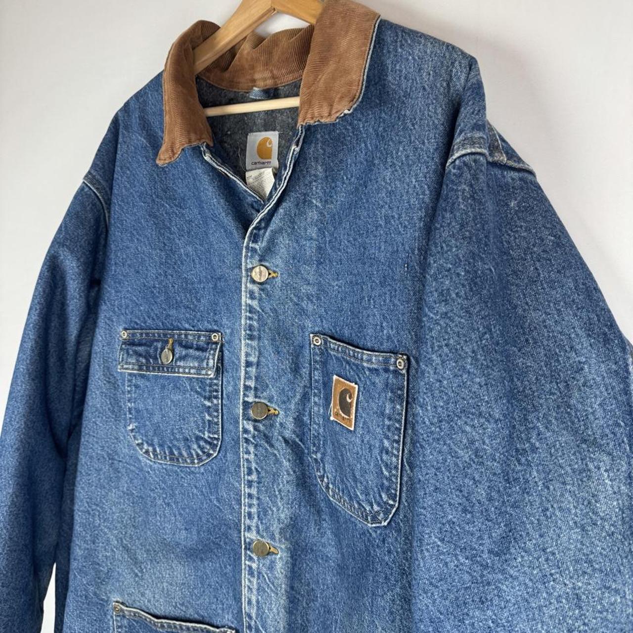 Carhartt denim chore jacket oversized 1990s style with classic logo and blue wash.