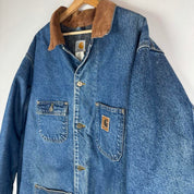 Carhartt denim chore jacket oversized 1990s style with classic logo and blue wash.