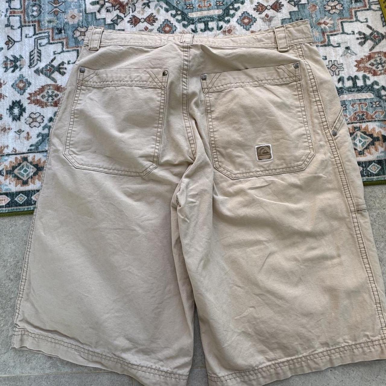 Quiksilver cream jorts with classic logo patch and vintage style from early 2000s.