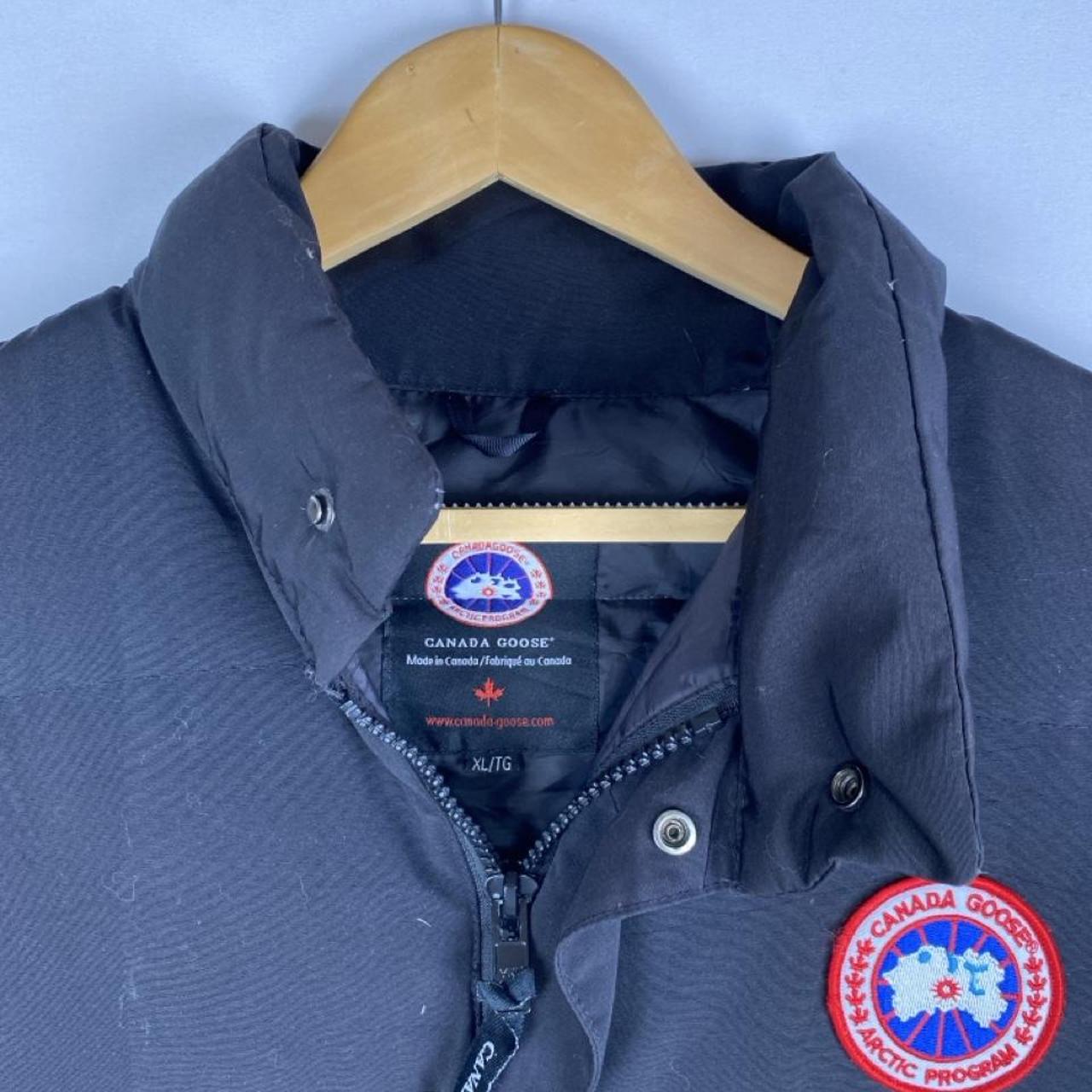 Canada Goose black down filled gilet with logo patch and zippered pockets.