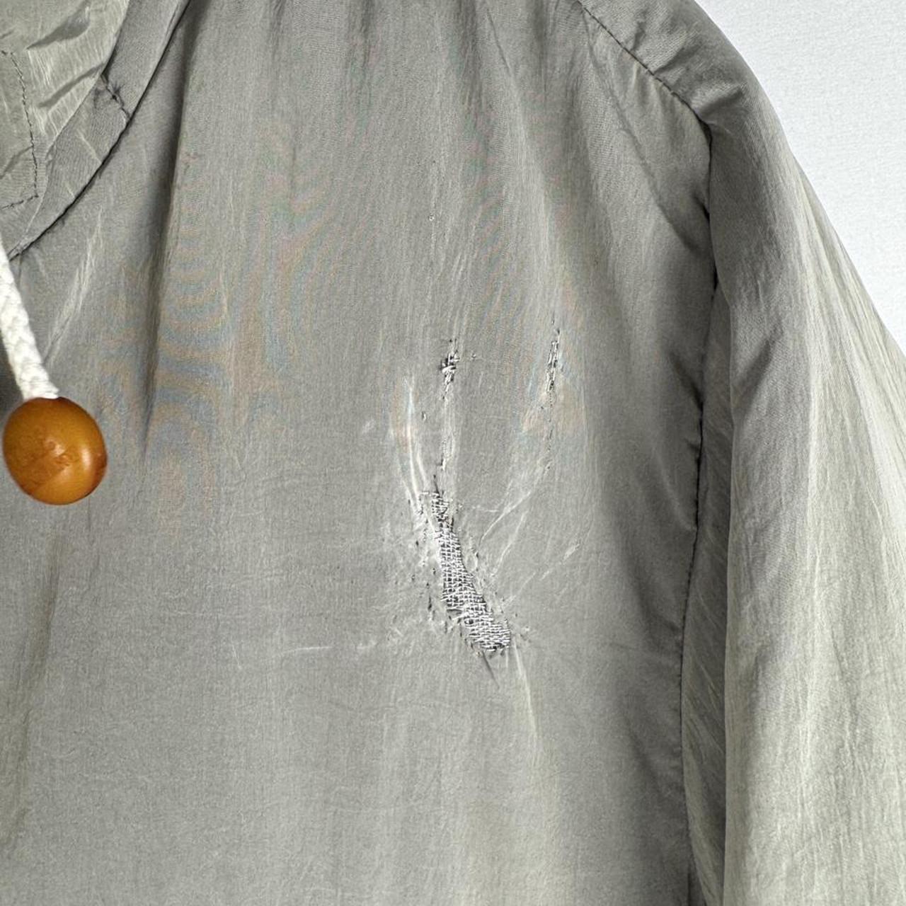 CP Company multi-colour utility parka jacket with multiple pockets and hood.